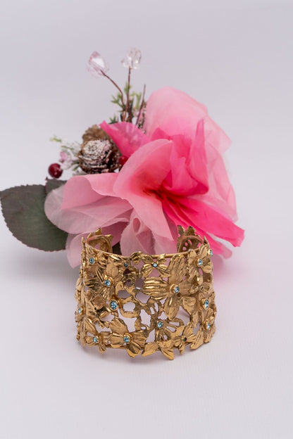 Yves Saint Laurent golden cuff bracelet with blue rhinestones