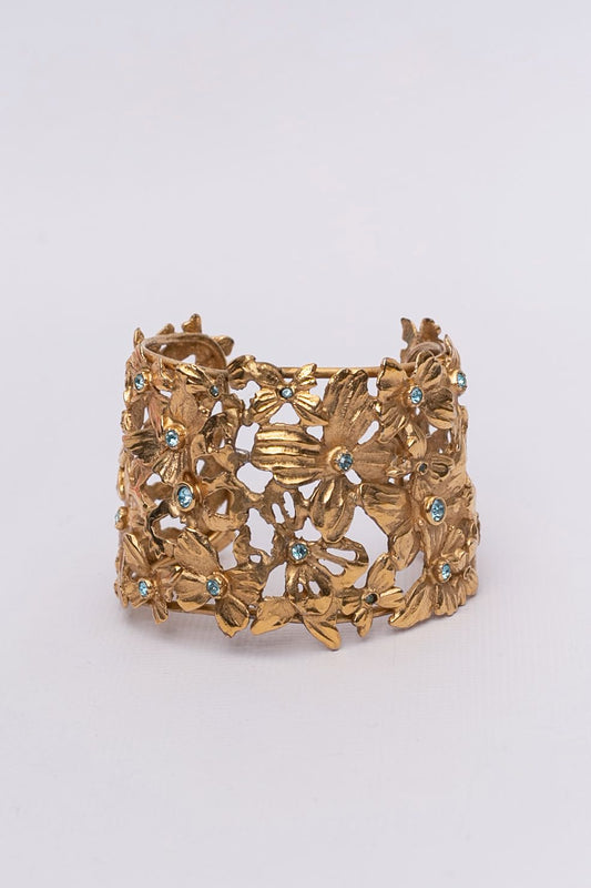Yves Saint Laurent golden cuff bracelet with blue rhinestones