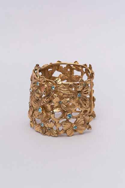 Yves Saint Laurent golden cuff bracelet with blue rhinestones