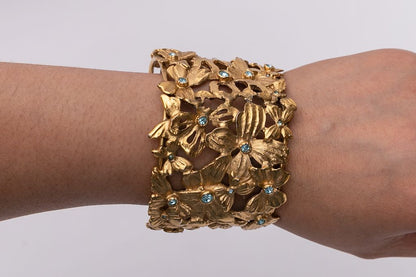 Yves Saint Laurent golden cuff bracelet with blue rhinestones